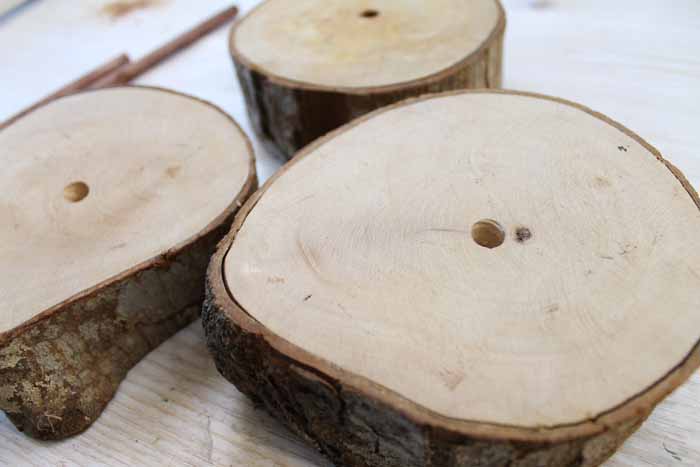 holes drilled in center of wood slices