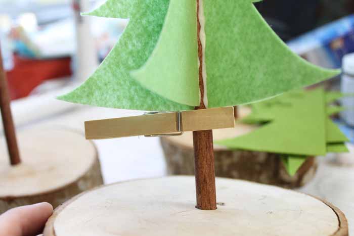 using a clothespin to hold up felt pieces while they dry