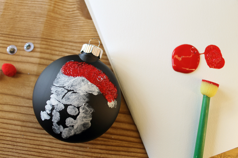 adding red details to santa handprint