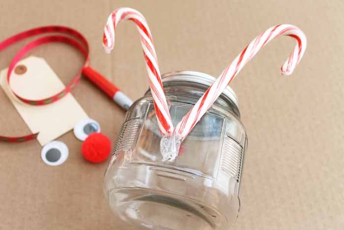 candy canes glued to the back of a jar