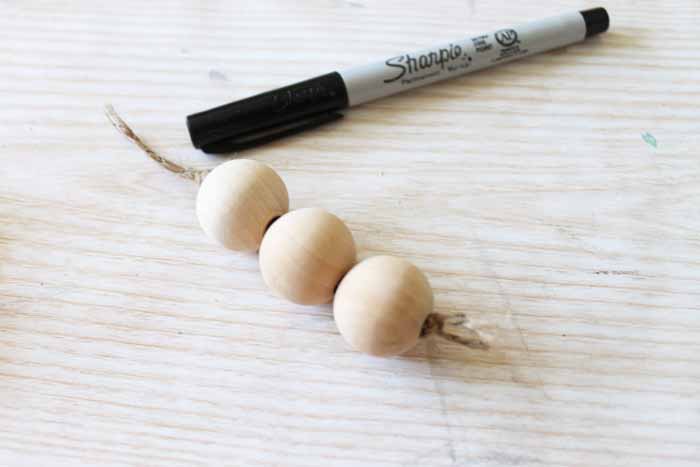 three wood beads on a string