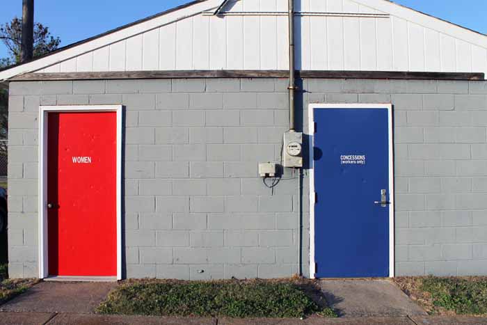 steel doors on a building with red and blue paint