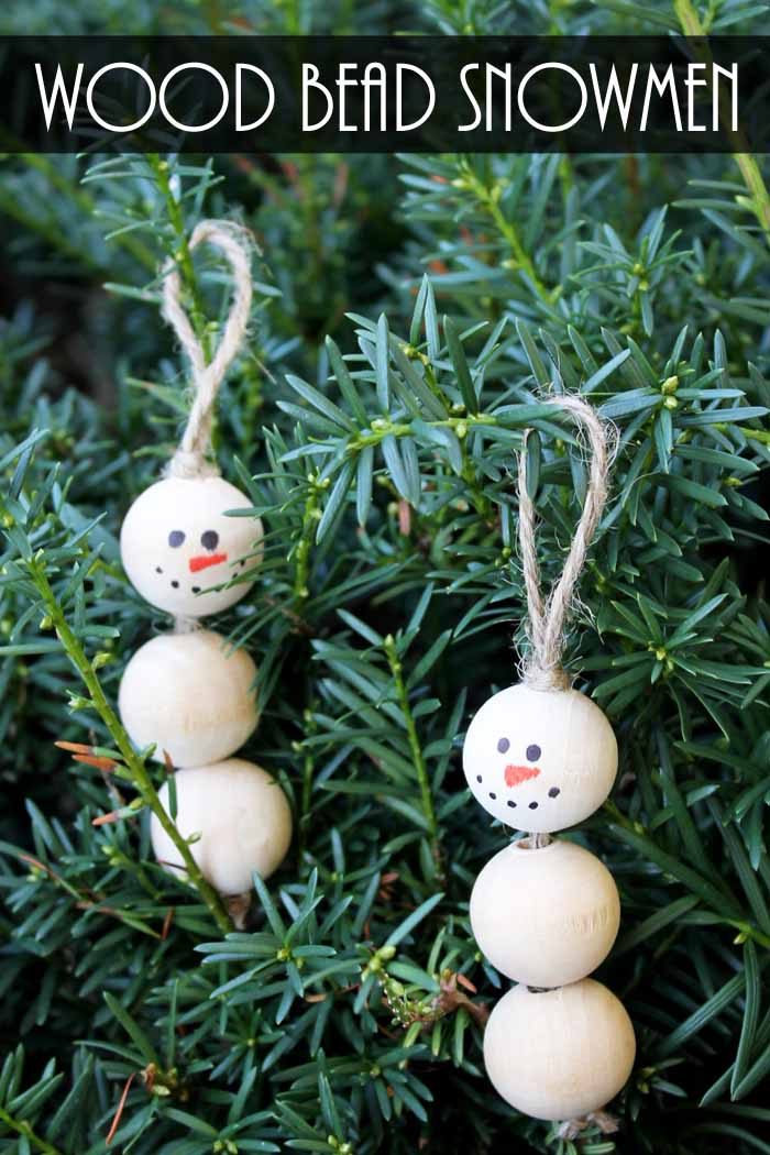 snowman decorations hanging on a christmas tree
