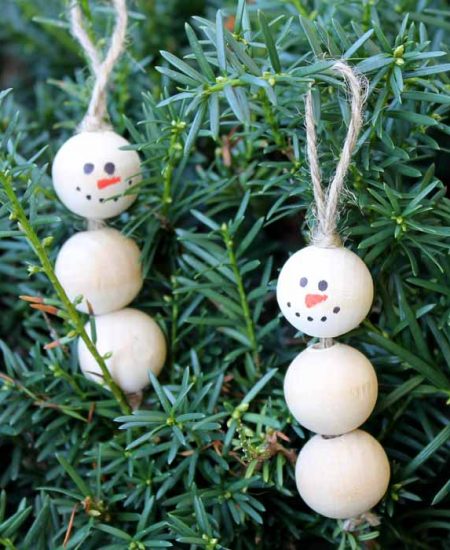 wooden snowman ornament on a tree