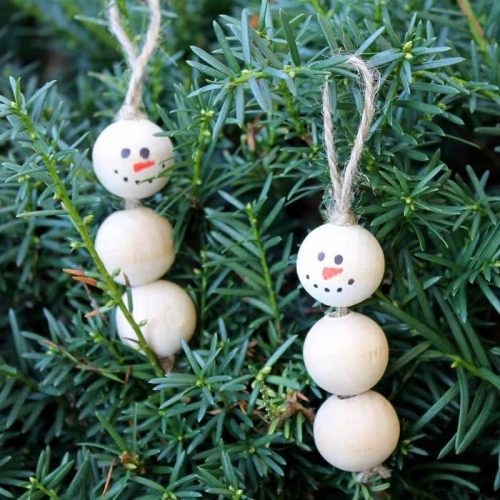 wooden snowman ornament on a tree