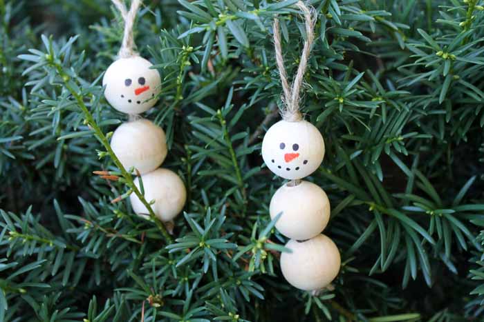wood bead snowman ornaments on a tree