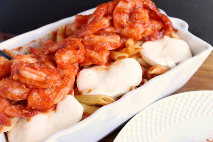 shrimp pasta with mozzarella in a casserole dish