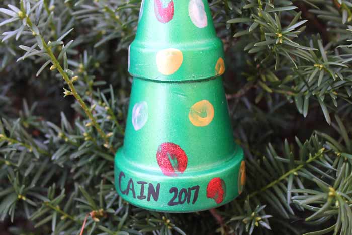 close up of name and year painted on a clay pot