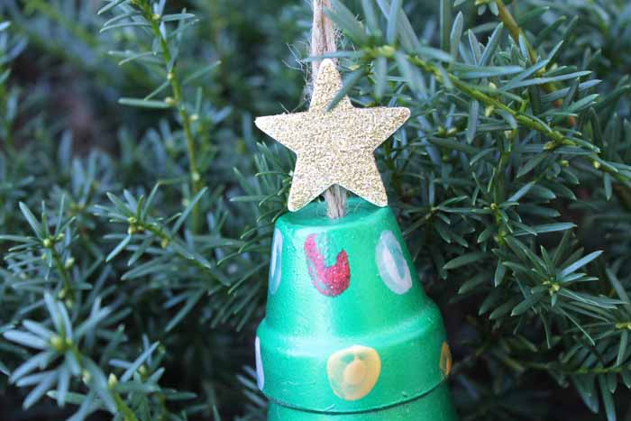 gold glitter star on top of a Christmas tree ornament