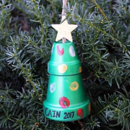 thumbprint art on clay pots hanging on a christmas tree