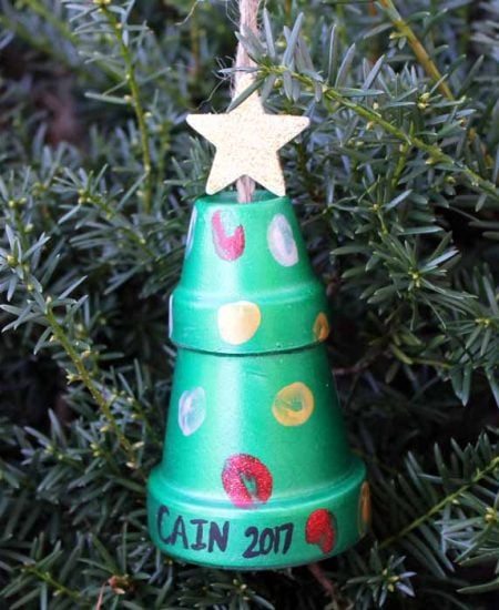 thumbprint art on clay pots hanging on a christmas tree