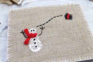 snowman painted on a piece of burlap