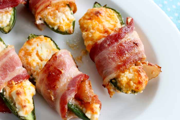 baked stuffed jalapenos on a white plate