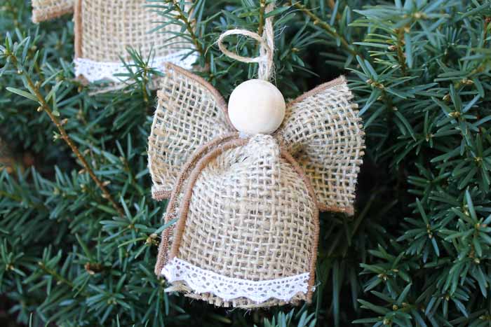 Close-up of one homemade burlap angel ornament hanging on a tree