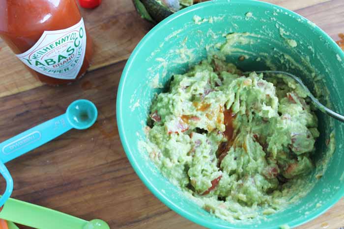 mixing avocado spread in a bowl