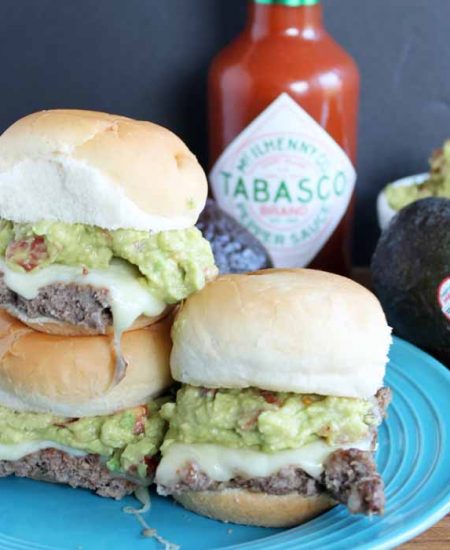 adding avocado spread to slider burgers