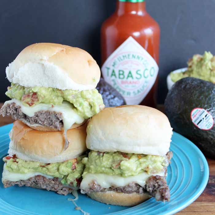 adding avocado spread to slider burgers