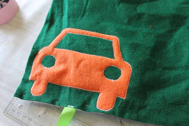 sewing around car cut from felt