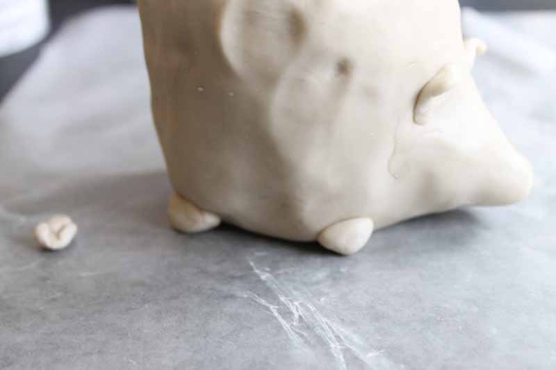 adding small feet to a clay hedgehog