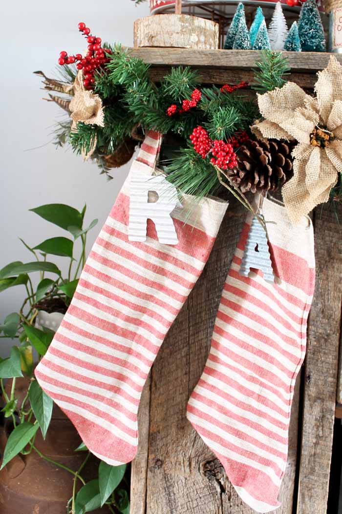 rustic stockings hanging from a barnwood mantel