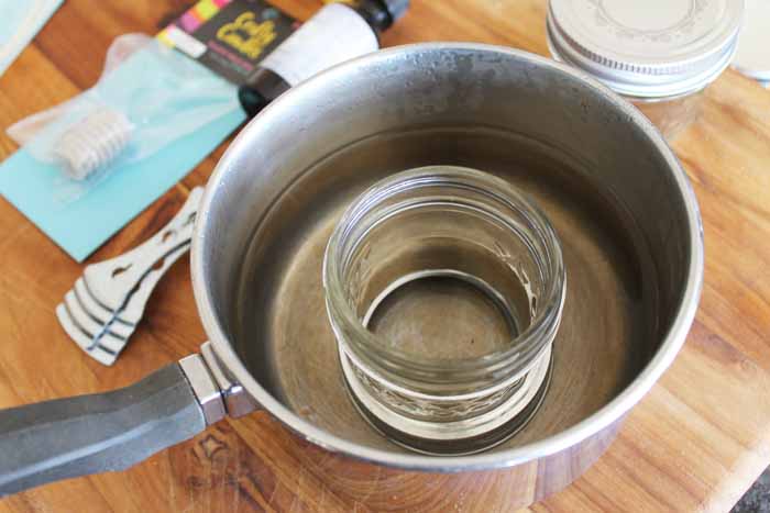 melting beeswax in a small mason jar