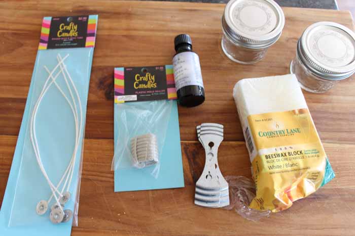 supplies to make candles on a cutting board