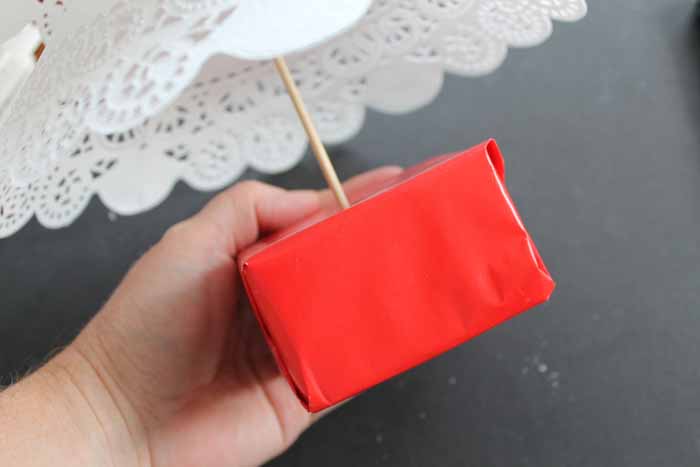 adding wrapping paper to a styrofoam block