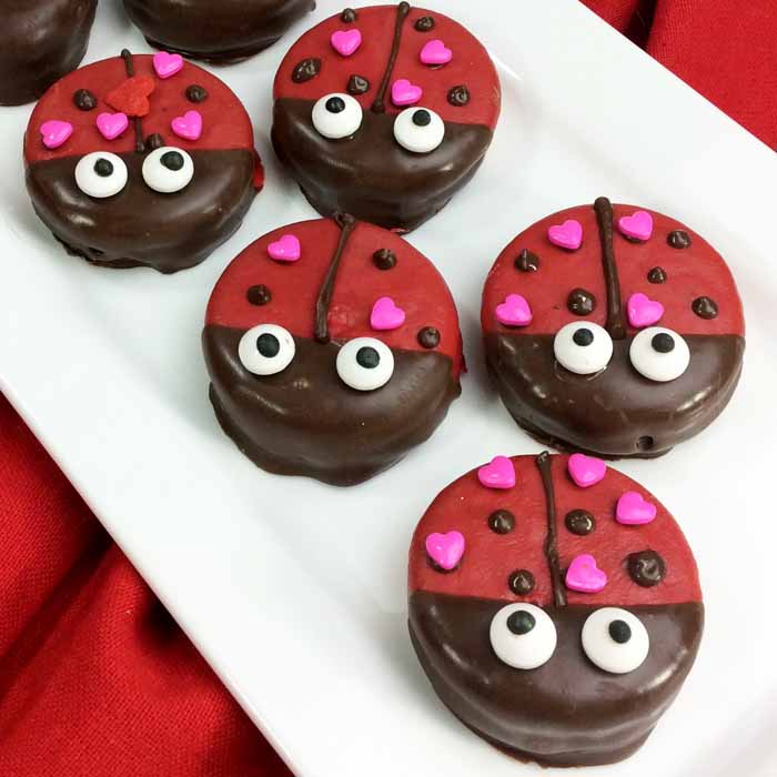 Make these Valentine cookies for someone you love! Cute covered Oreos that look like lady bugs! So simple and no baking required!