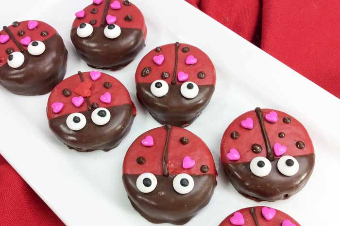 Make these Valentine cookies for someone you love! Cute covered Oreos that look like lady bugs! So simple and no baking required!