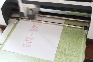 top shot of cheesy valentines being printed from Cricut machine
