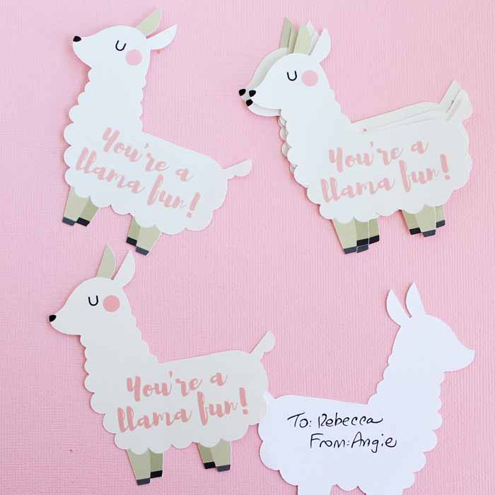 Cut-out white llama valentines on pink background