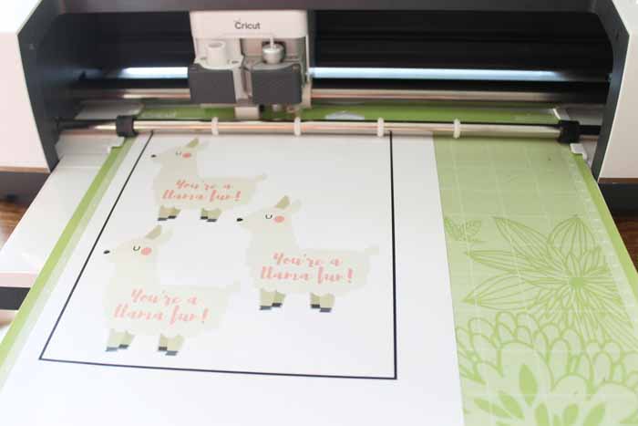 Llama valentines printed on white paper, going into Cricut machine