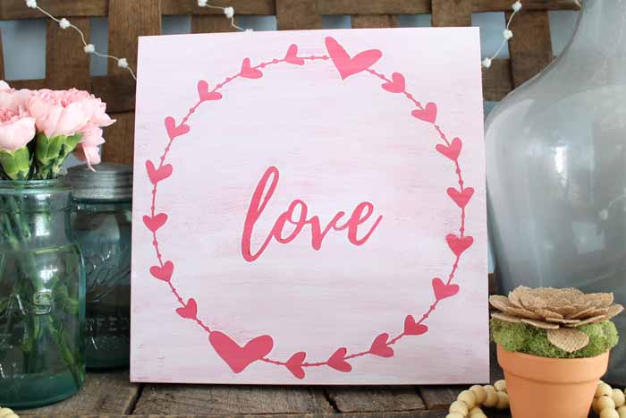 rustic love wall art on a mantel