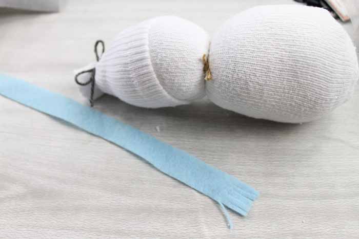 cutting a felt scarf for a sock snowman