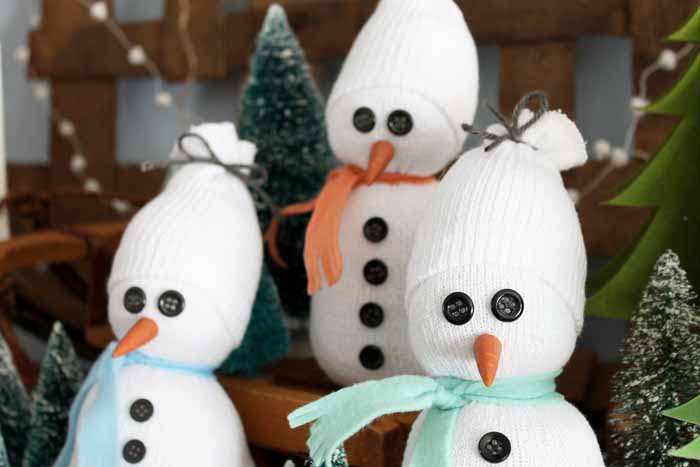 Close up of three DIY sock snowmen.