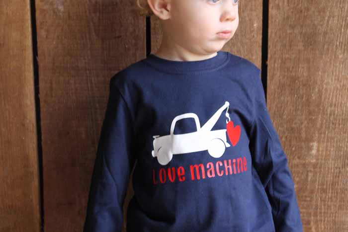A little boy wearing a blue shirt with valentine design