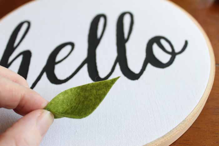 hello wall craft in embroidery hoop with a felt leaf