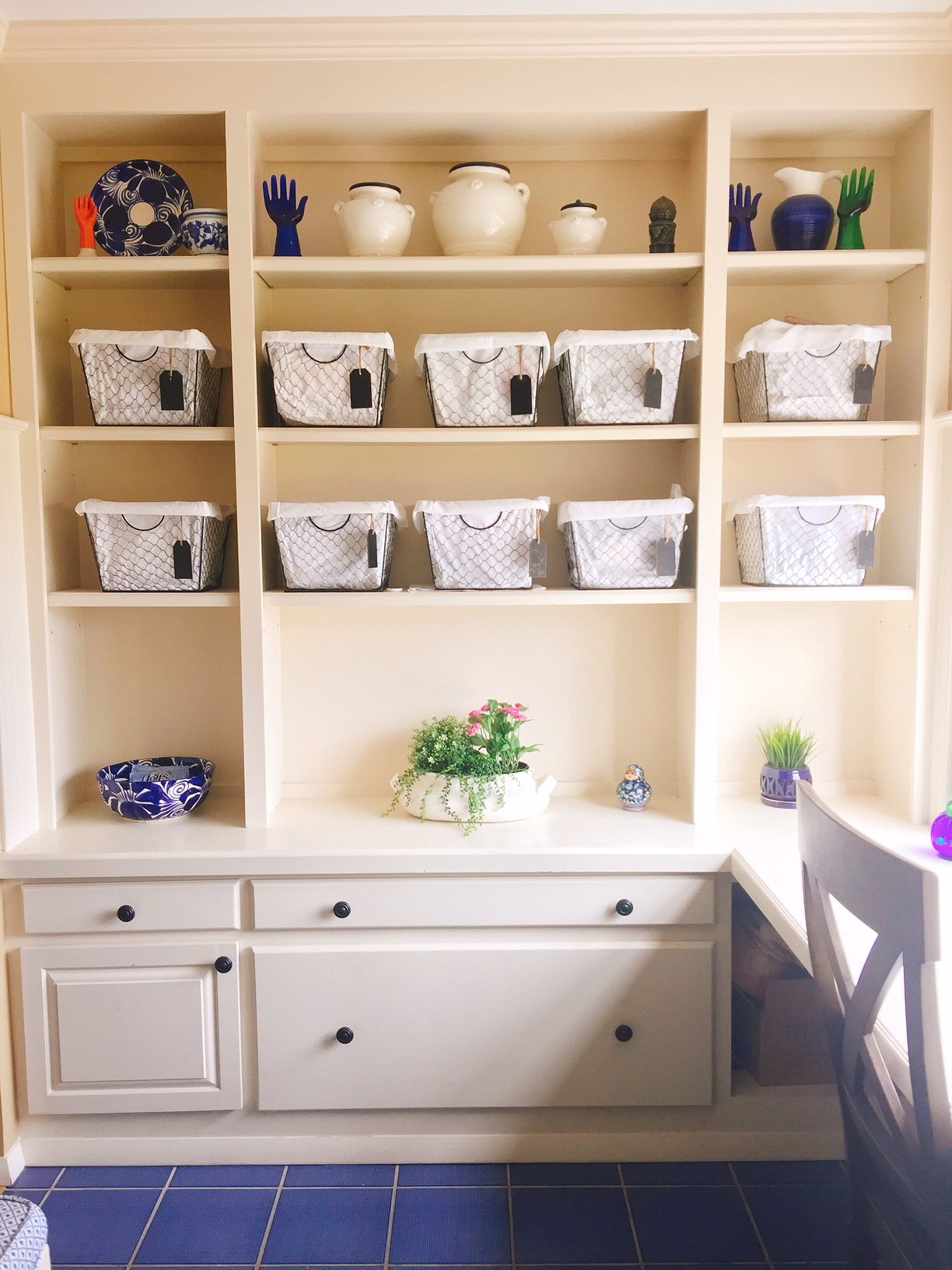 white shelves with baskets for craft supplies