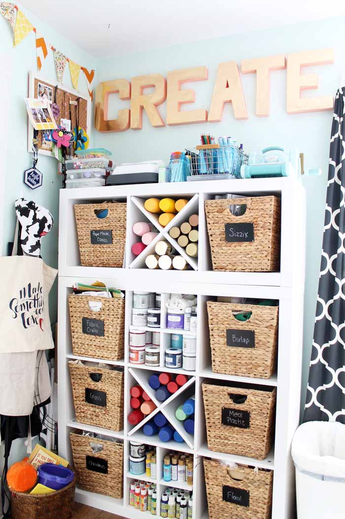 craft room shelves with letters on the wall