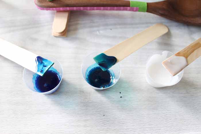 blue and green resin mixed in cups