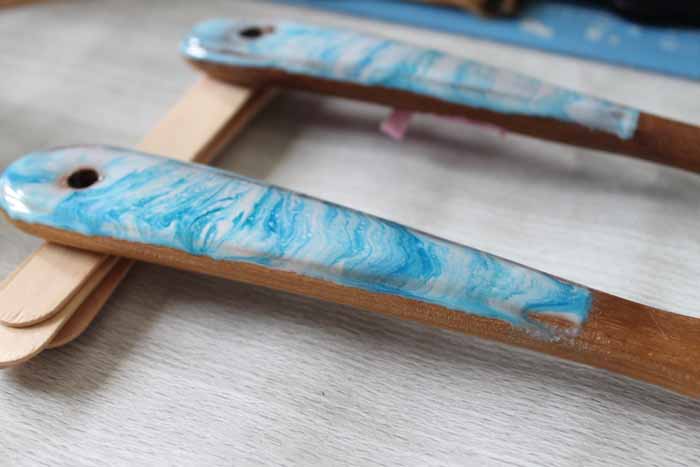 resin curing on the handles of wood spoons