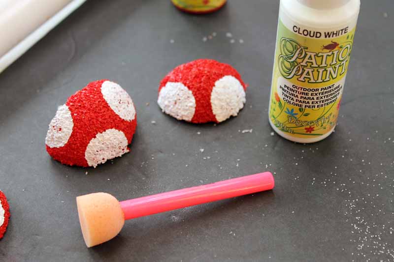 painting tops of mushrooms made from styrofoam
