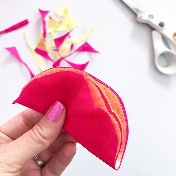 Folded 3-inch rounds of colored tissue paper for tissue paper flowers