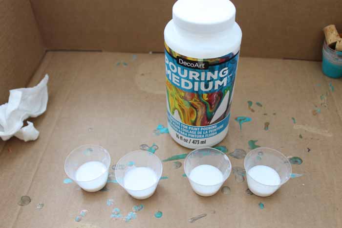 adding pouring medium to small disposable cups