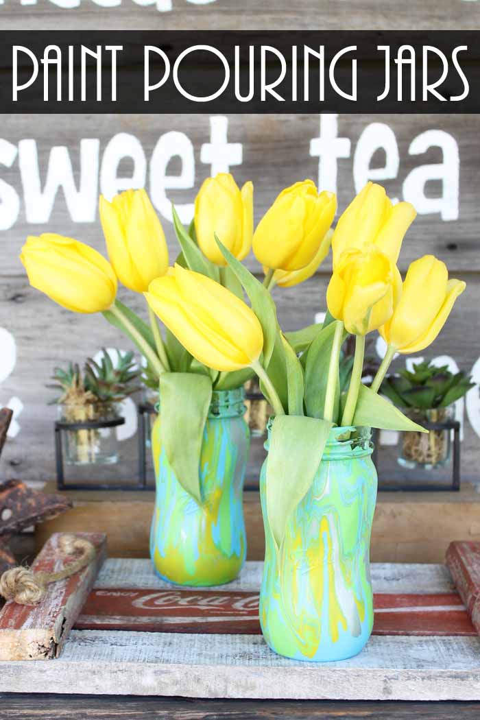 Try acrylic pouring on mason jars to make these spring vases! Paint pouring medium makes this a quick and easy project anyone would love!