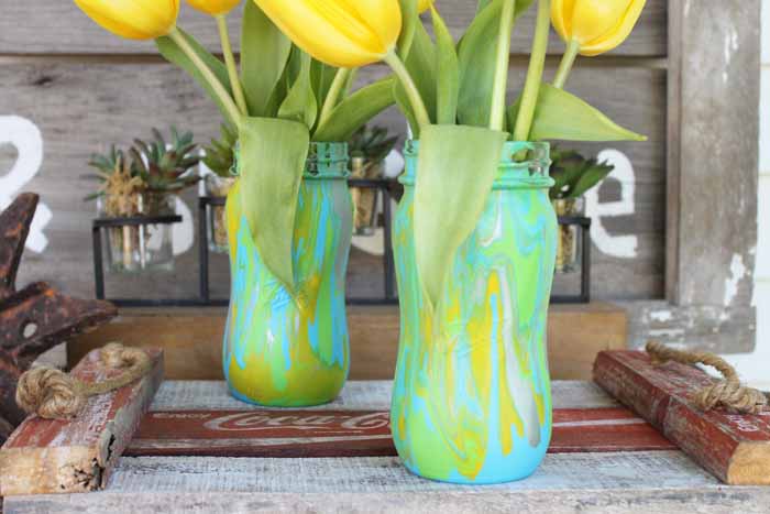 mason jar vases holding vases and decorated using the acrylic pour painting technique