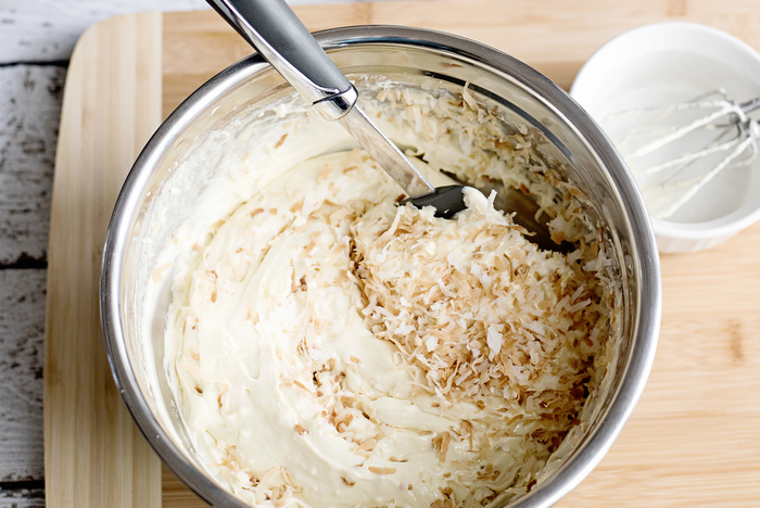 adding toasted coconut to cake batter