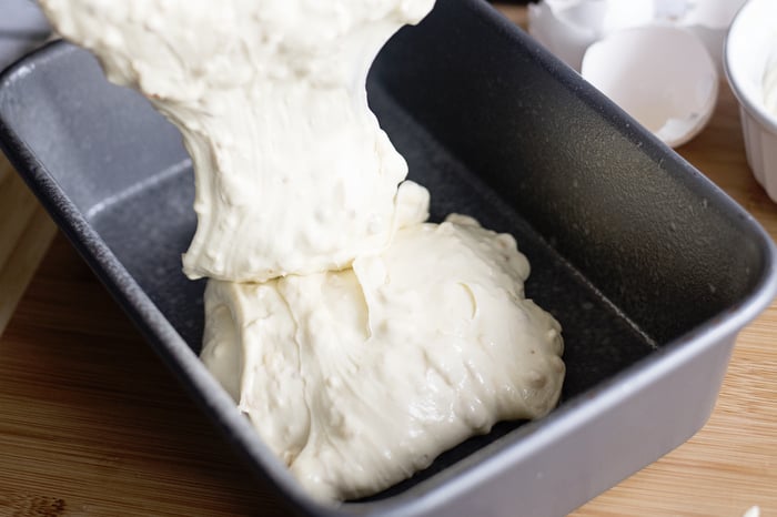 pouring cake batter into pan