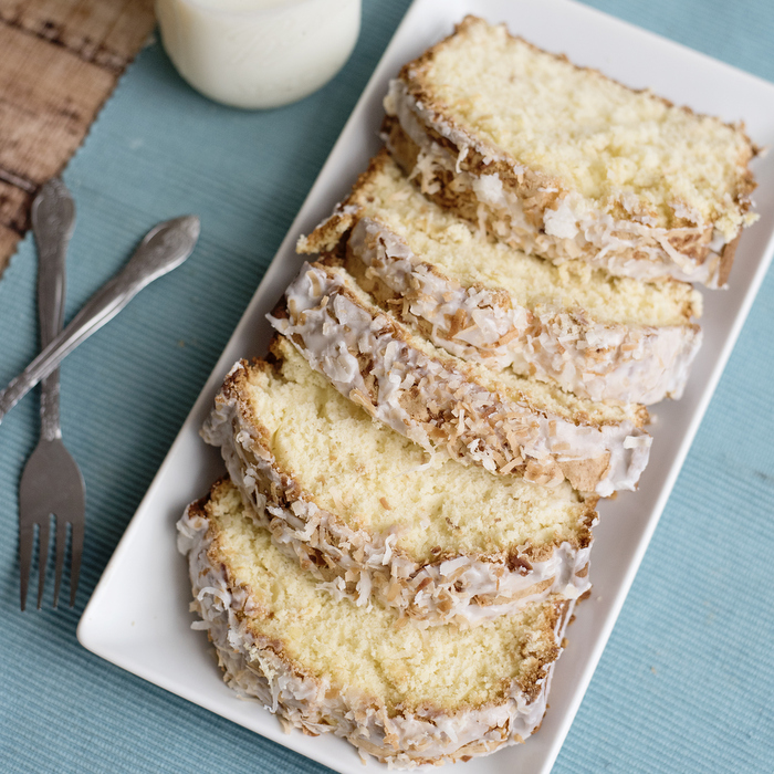 A piece of cake on a plate, with Coconut 