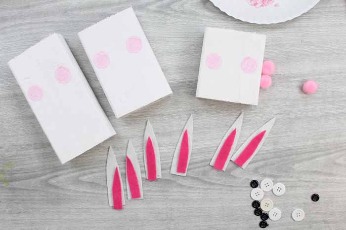 adding pink circles to scrap wood and ear supplies